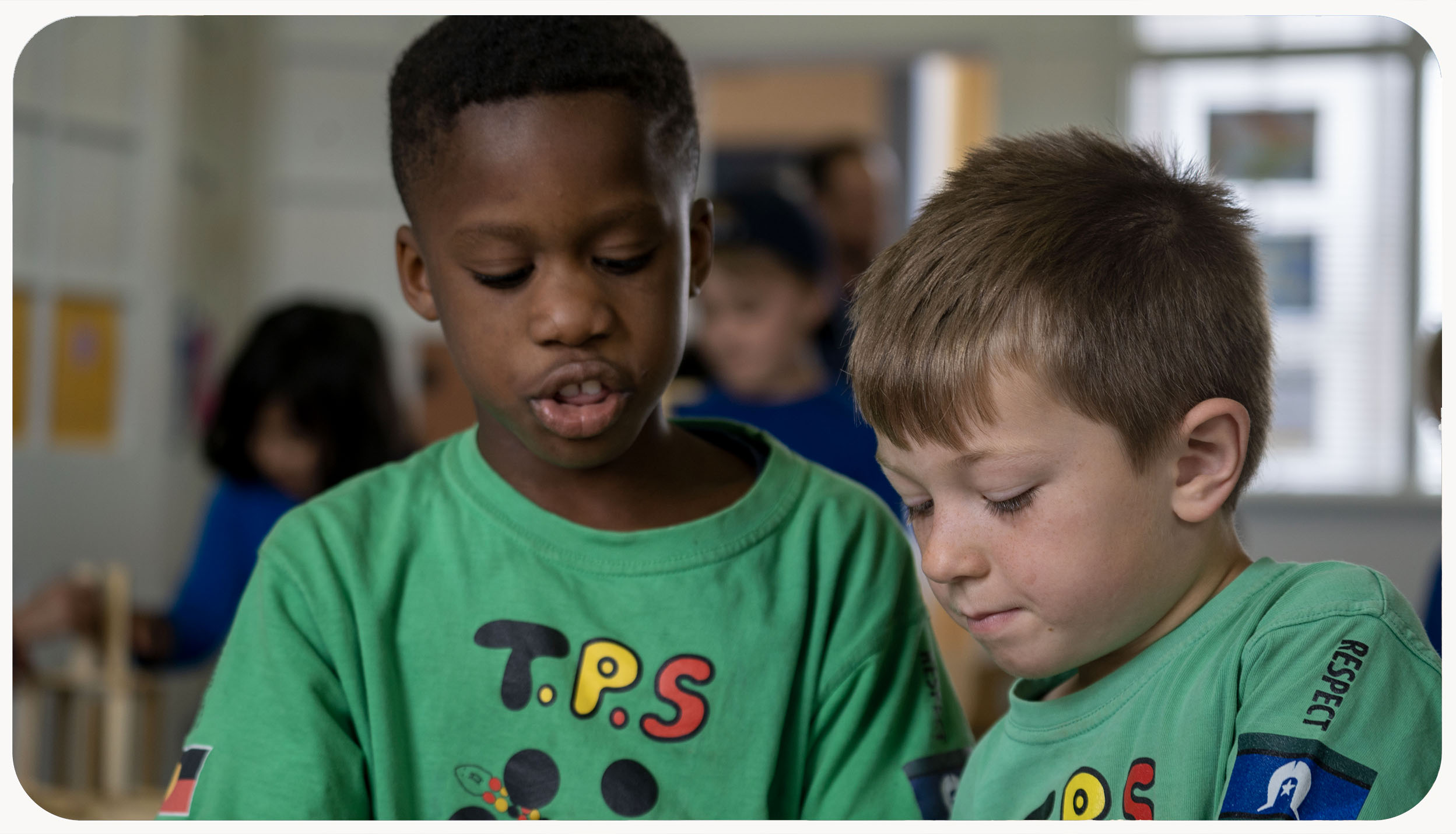 Two children working in a classroom