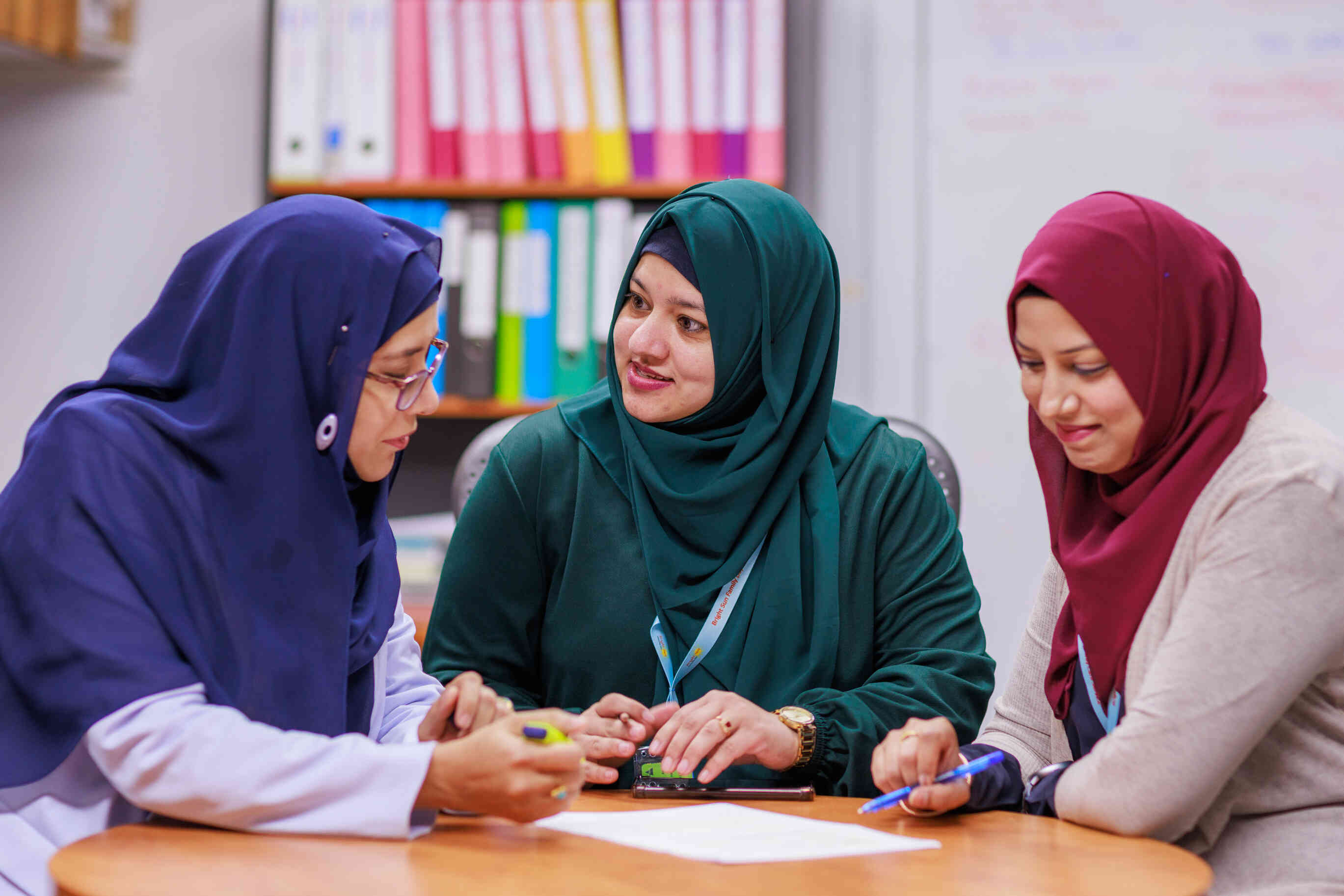 Educators talking with each other at a table 