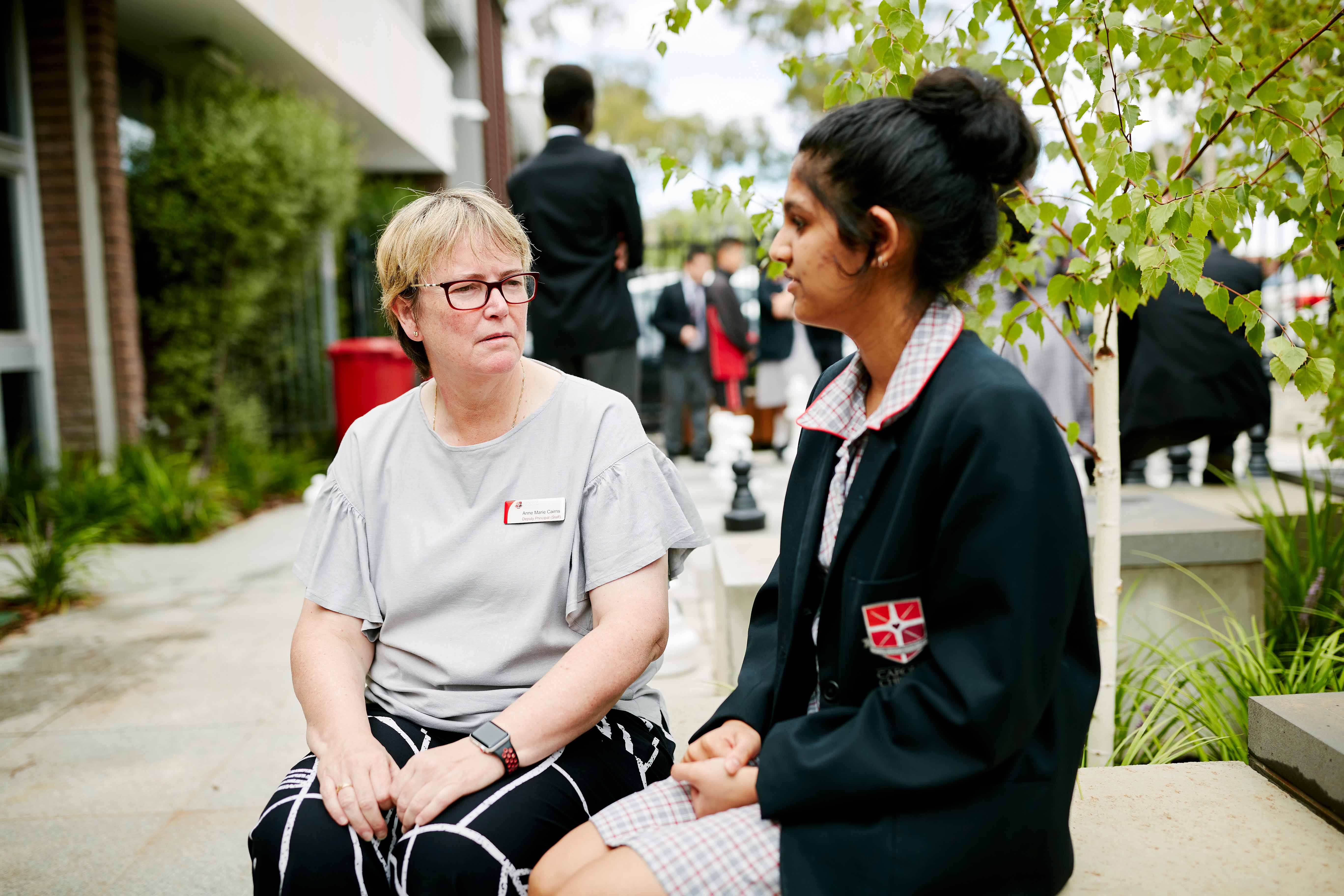 Educator and student in a conversation outside