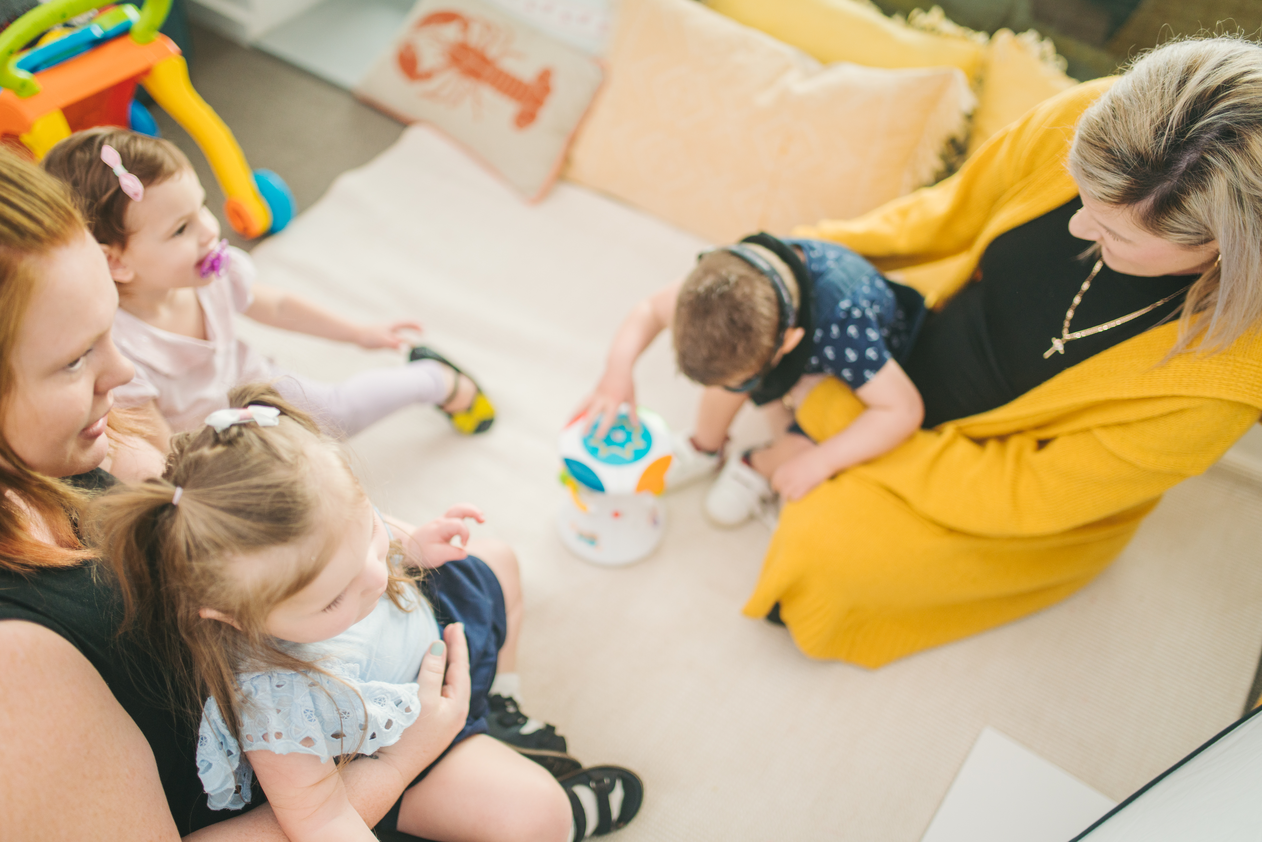 Two adults playing with toddlers at an early learning service