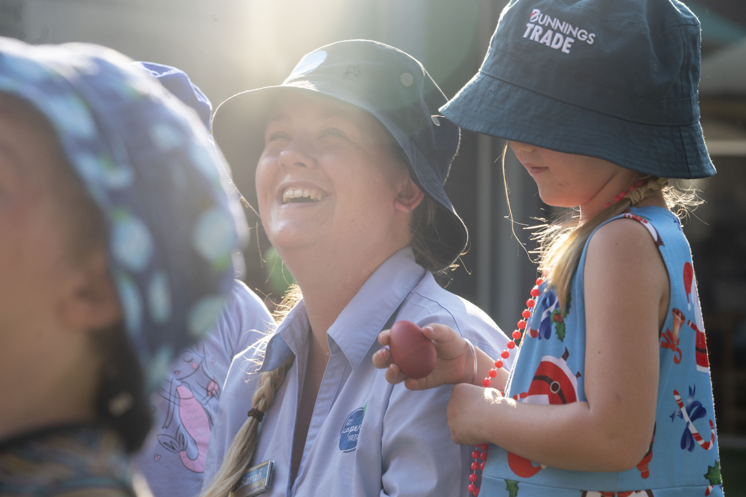 An educator sitting among young children