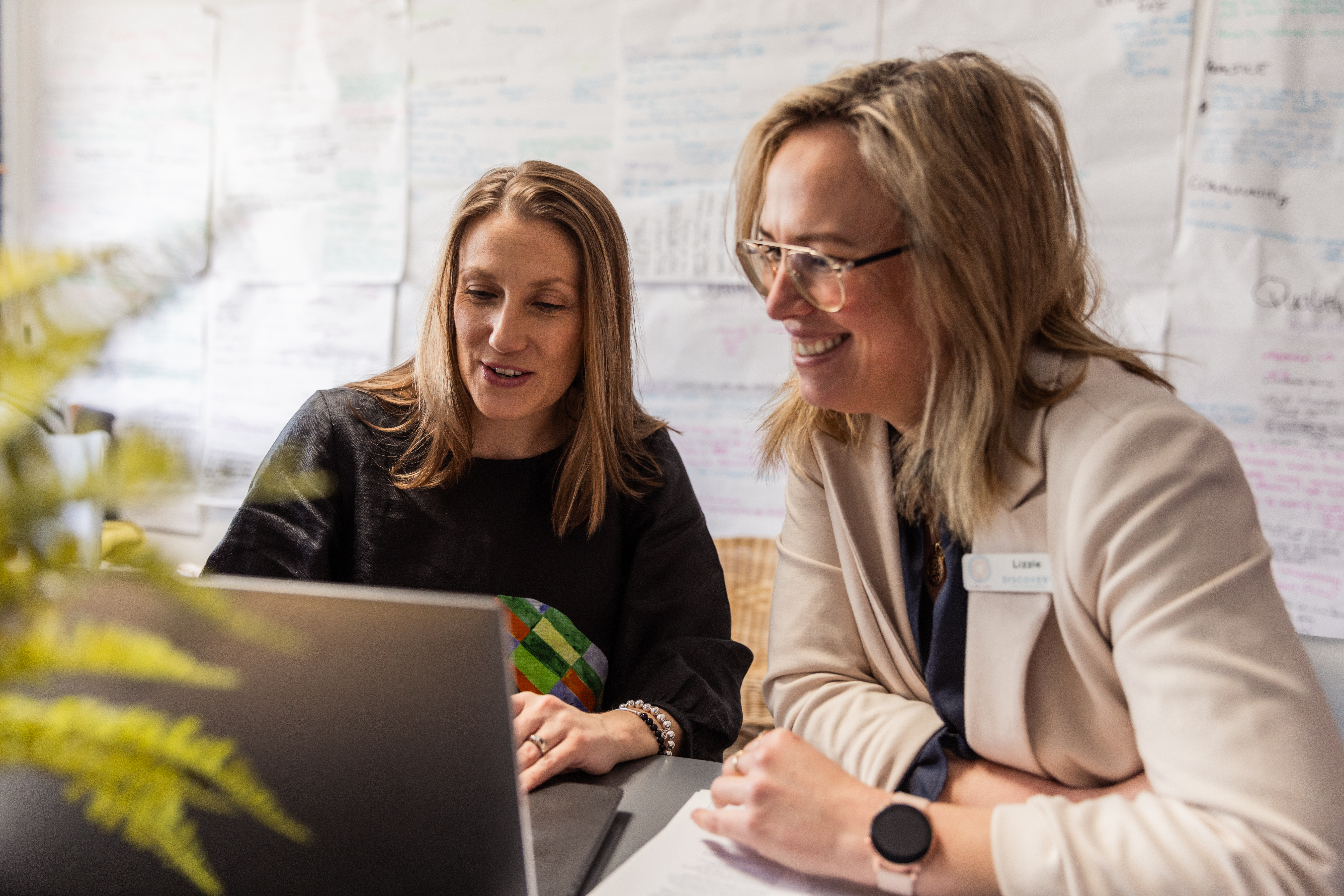 Two educators looking at a computer screen