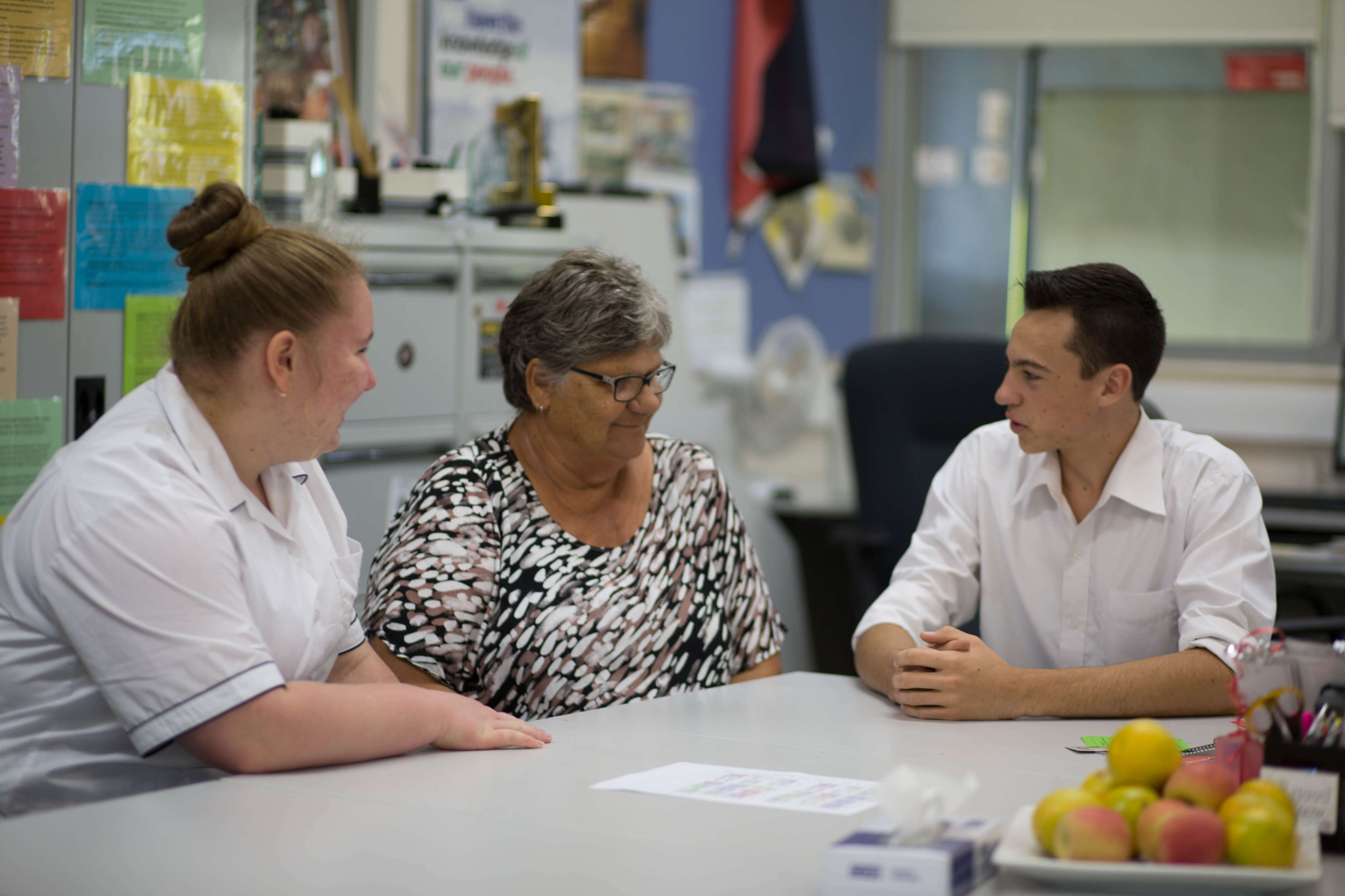 Educators sitting at a table, engaged in conversation