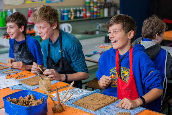 A group of young people in an art class, laughing