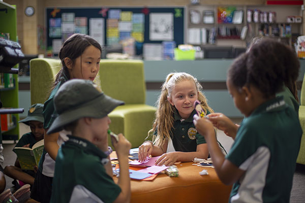 A group of children working together in a classroom 